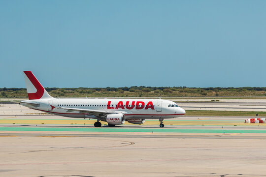 Lauda Passenger Airplane in Side Profile on Airport Apron