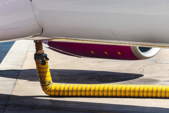 Close-Up of Aircraft Underside and Yellow Ground Service Hose