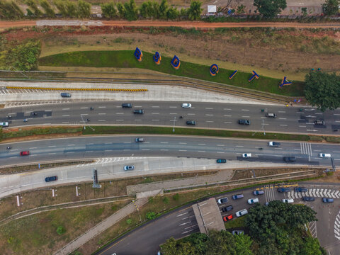 Aerial view of the BSD City sign situated along a multi-lane highway with flowing traffic in Serpong Sub-District, Banten, Indonesia.
