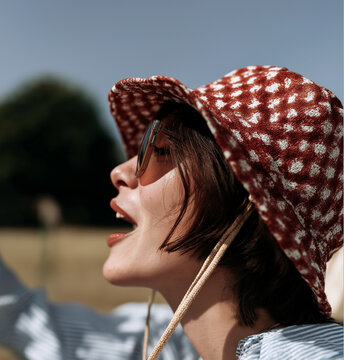 Woman in White Blouse Wearing Sculptural Lobster Hat. Ideal for surreal fashion, seafood editorials, and artistic branding.