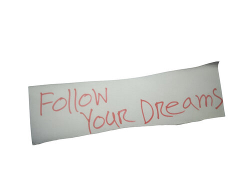 Follow your dreams handwritten message on a small piece of paper isolated on transparent background