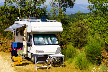 Clothes hanging to dry outdoors by camping car. Caravan vacation.