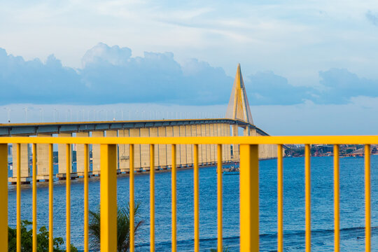 Cable Stayed Bridge Over Water Behind Yellow Railing