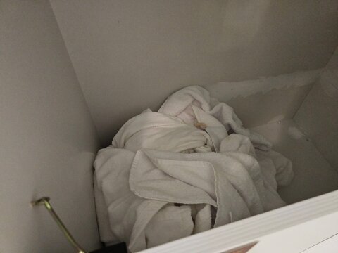 Towels are filled in a storage box in a bathroom