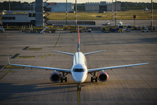 Beograd, Serbia - 08 January 2014: Aerial view of Belgrade Nikola Tesla Airport with a commercial passenger airplane parked on the tarmac during the golden hour.
