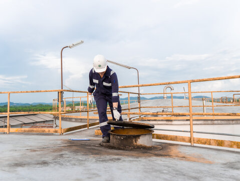Petrochemical Engineers checking reports for technical inspections in oil refinery. Technicians working on checklist in the oil storage tank area. Factory and industry manufacturing. Oil tank.