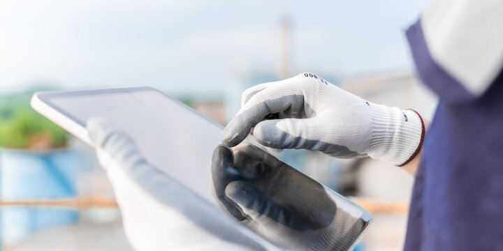 Environmental engineering using digital tablet check report environment clean air of air pollution reduction industrial plants. Engineer analysis sustainable energy saving with sky sunset. ESG. CEMS