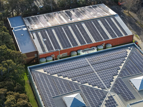 Wantirna South, Victoria, Australia - 03 September 2026: Aerial view of Knox Data Centre featuring extensive solar panel arrays on the rooftops, surrounded by trees and urban infrastructure.