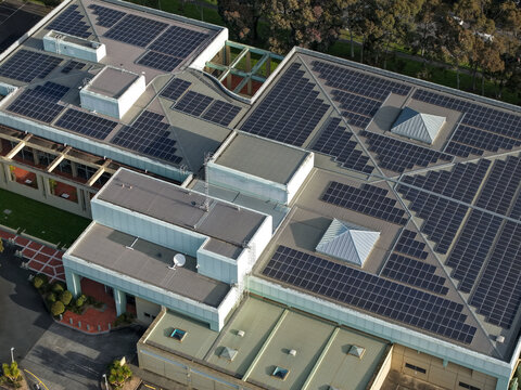 Wantirna South, Victoria, Australia - 03 September 2026: Aerial view of Knox Data Centre featuring extensive solar panel arrays on its roof, surrounded by green trees and paved areas.