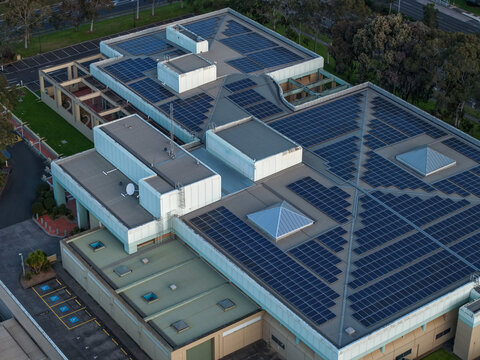 Wantirna South, Australia - 03 September 2026: Aerial view of Knox Data Centre featuring extensive solar panel arrays on the roof, surrounding parking areas, and nearby greenery.