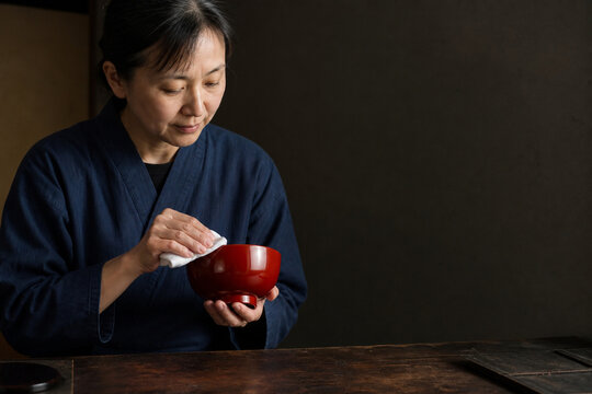 Japanese Lacquer Artisan Polishes a Deep Red Bowl