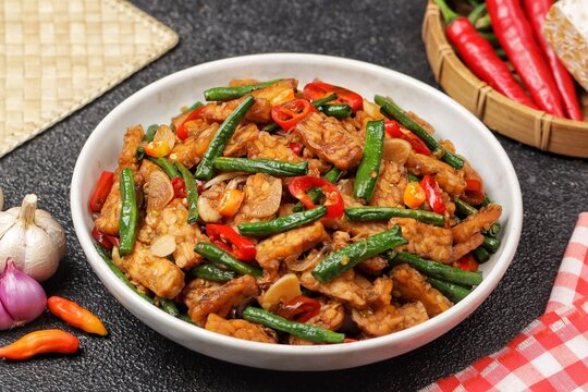 oseng tempe kacang panjang or stir-fried tempeh with long beans, cooked with garlic, shallots, chilies, and savory seasonings.
