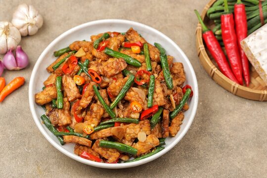 oseng tempe kacang panjang or stir-fried tempeh with long beans, cooked with garlic, shallots, chilies, and savory seasonings.