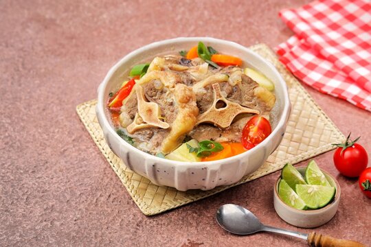 Sop buntut or oxtail soup, a traditional Indonesian oxtail soup made with tender beef oxtail simmered in a rich and flavorful broth with vegetables and aromatic spices..ribs soup
