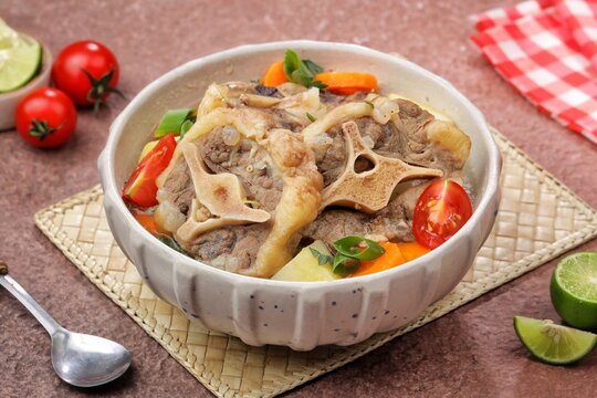 Sop buntut or oxtail soup, a traditional Indonesian oxtail soup made with tender beef oxtail simmered in a rich and flavorful broth with vegetables and aromatic spices..ribs soup