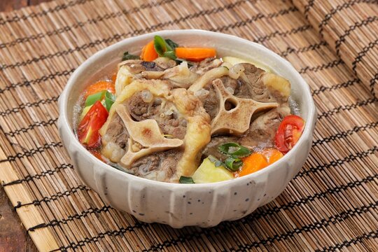 Sop buntut or oxtail soup, a traditional Indonesian oxtail soup made with tender beef oxtail simmered in a rich and flavorful broth with vegetables and aromatic spices..ribs soup