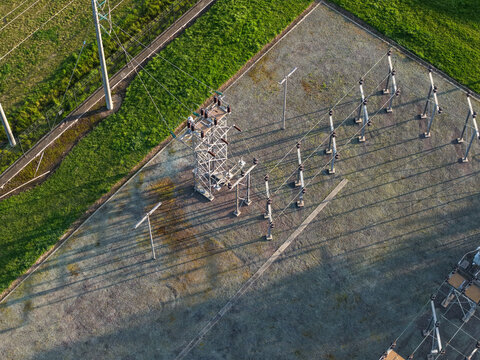 Croydon, Victoria, Australia - 02 September 2026: Aerial view of Croydon Zone Substation with electrical towers, power lines, and long shadows on the gravel ground.