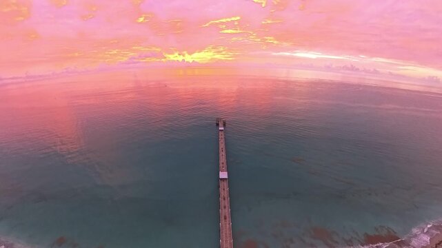 Travel and Nature: 4K Aerial Drone View of a Spectacular Sunrise Over the Atlantic Ocean and Juno Beach Pier, Florida