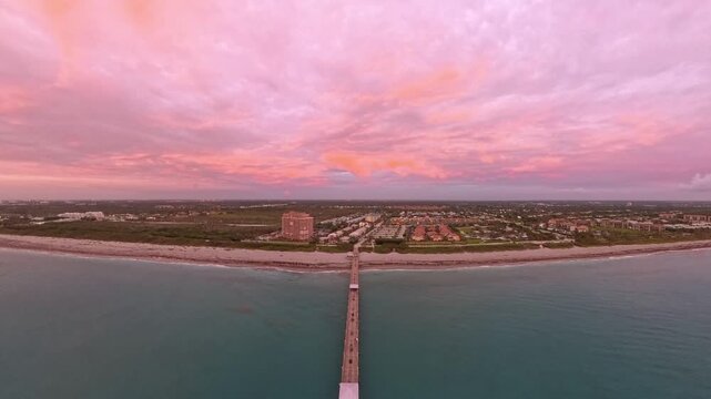 Travel and Nature: 4K Aerial Drone View of a Spectacular Sunrise Over the Atlantic Ocean and Juno Beach Pier, Florida