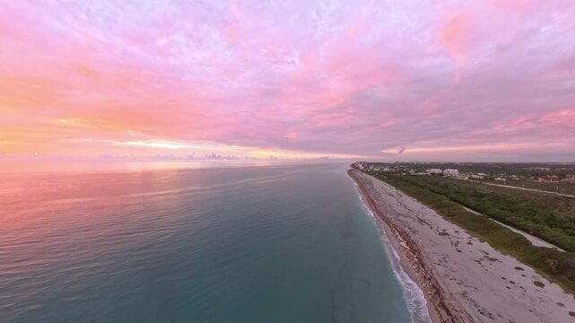 Travel and Nature: 4K Aerial Drone View of a Spectacular Sunrise Over the Atlantic Ocean and Juno Beach Pier, Florida