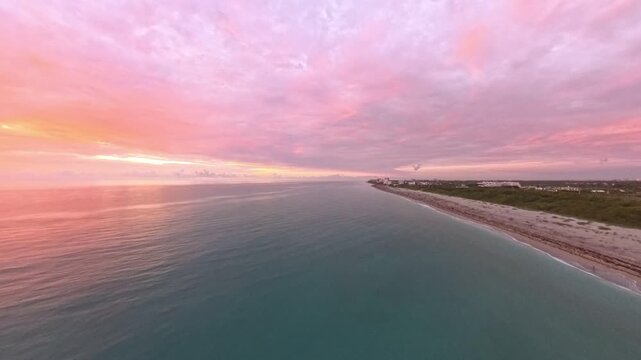 Travel and Nature: 4K Aerial Drone View of a Spectacular Sunrise Over the Atlantic Ocean and Juno Beach Pier, Florida