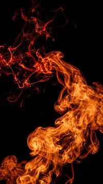 Swirling crimson and orange smoke patterns against a black background, representing energy, transformation, and passion