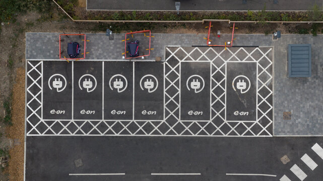 Doncaster, England, United Kingdom - 14 July 2026: Aerial view of an electric vehicle charging station with parking bays marked with E.ON branding and charging symbols on asphalt.