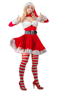 Mrs. Santa Claus smiling happily. Pretty woman in red dress, white fur. Cheerful girl in Santa&rsquo;s hat.