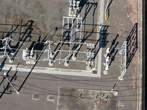 Chirnside Park, Australia - 01 September 2026: Aerial view of Chirnside Park Zone Substation with electrical infrastructure, metal structures, and long shadows cast on the ground.