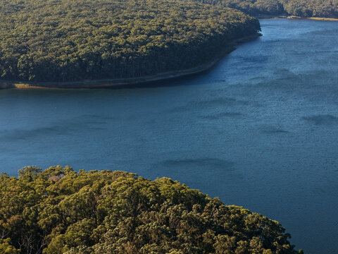 Silvan, Victoria, Australia - 01 September 2026: Aerial view of Silvan Reservoir Park, featuring expansive blue reservoir water surrounded by dense green eucalyptus forests.