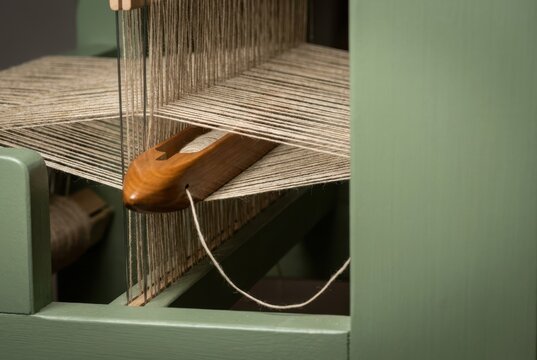 Weaving loom with warp threads in textile workshop
