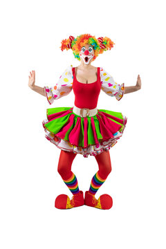 Surprised female clown, woman entertainer dressed as a colorful Joker in a suit and wig, with clown whiteface makeup. She is a trickster, jester, pantomime, mime