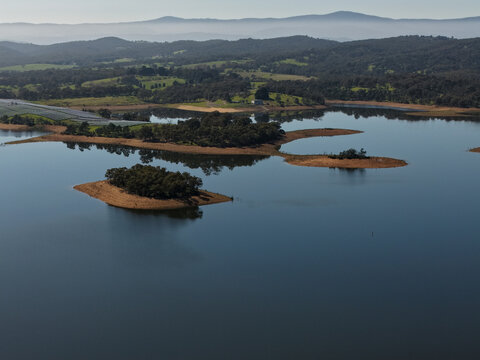 Christmas Hills, Australia - 31 August 2026: Aerial view of Sugarloaf Reservoir with calm water, small islands covered in trees, and rolling hills in the background.