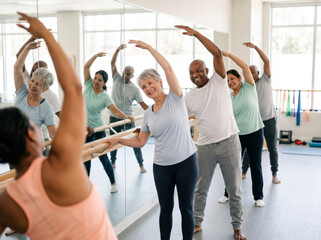 Rehabilitation patients stretching at a support barre in a bright studio, ideal for physical therapy and community wellness campaigns. © Tania Zbrodko