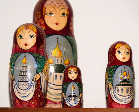 Traditional hand-painted Russian Matryoshka nesting dolls featuring Orthodox church architecture. Wooden babushka dolls arranged by size, representing concepts of family, heritage, and descending hier