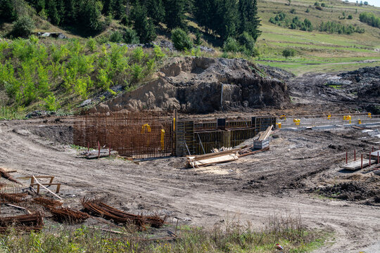 Empty construction site, reinforcing a small water reservoir dam in Romania.