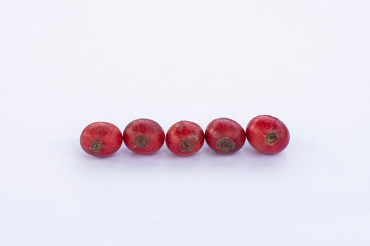 Liberica coffee (Coffea Liberica) on a white background, raw coffee. Large red Liberica coffee.