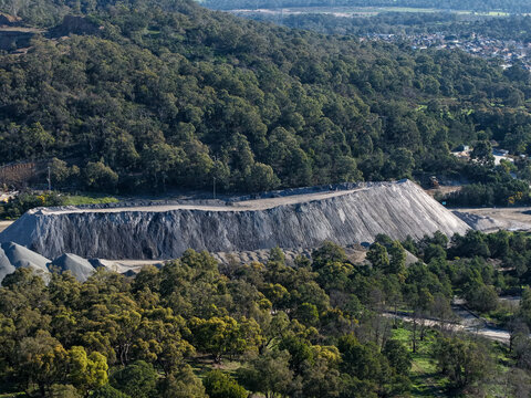 Lysterfield, Victoria, Australia - 30 August 2026: Aerial view of Boral Quarries showing the large excavated stone pit, surrounding dense eucalyptus forest, and industrial earthworks.