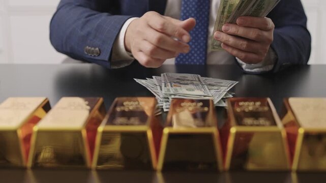 Successful rich man with gold. Business success man and gold bar. Investment in precious metal. Golden future. Golden bar. Rich businessman count gold bullion. Financial success