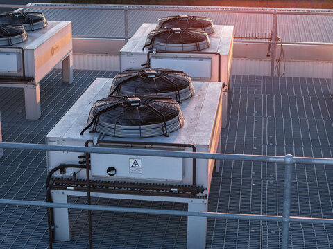 Kilsyth South, Victoria, Australia - 29 August 2026: Aerial view of Micron21 Data Centre rooftop featuring industrial cooling fans and HVAC units on metal grating during sunset.
