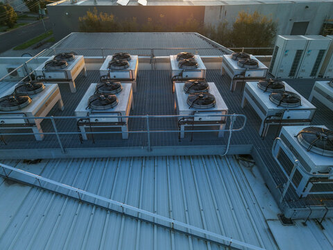 Kilsyth South, Victoria, Australia - 29 August 2026: Aerial view of Micron21 Data Centre rooftop featuring industrial HVAC cooling units on a metal grating platform during golden hour.