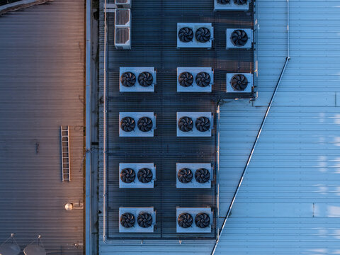 Kilsyth South, Victoria, Australia - 29 August 2026: Aerial view of Micron21 Data Centre roof with rows of industrial HVAC cooling fans, metal panels, and a maintenance ladder.