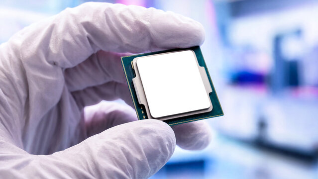 Hand in white glove holding a computer processor chip for hardware engineering and tech