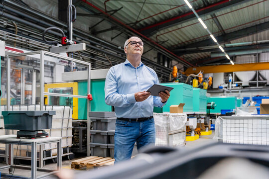 Male manager holds a tablet in the production hall