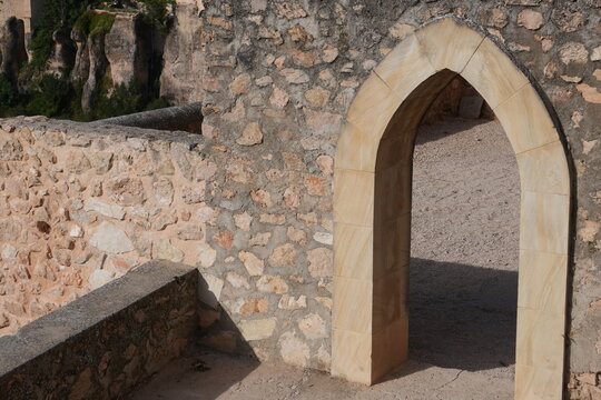 Historic stone pointed arch and masonry wall in Cuenca, Spain