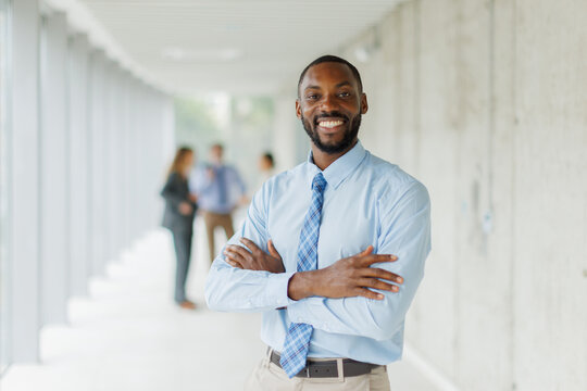 Smiling businessman shows confidence in a modern office