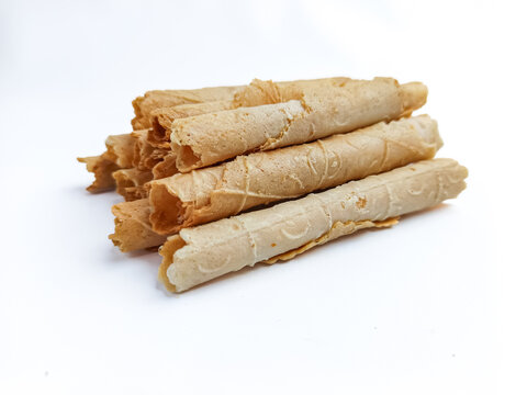 Close-up of (semprong in Indonesia) crispy rolled wafer cookies stacked together and isolated on a clean white background