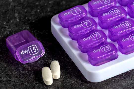 Monthly Pill Organizer with Tablets Removed from One Compartment