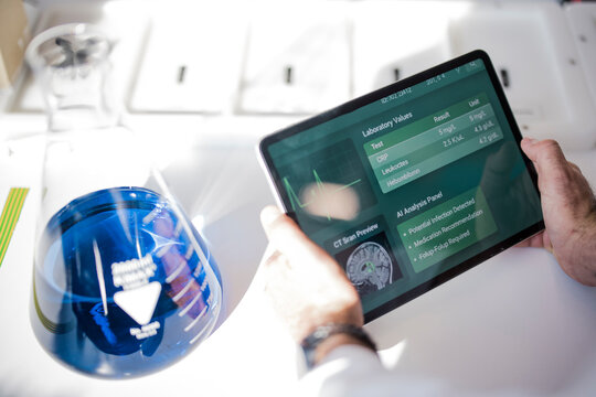 Scientist holds tablet with medical information in laboratory
