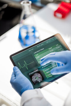 Scientist analyzes medical information on a tablet in the lab
